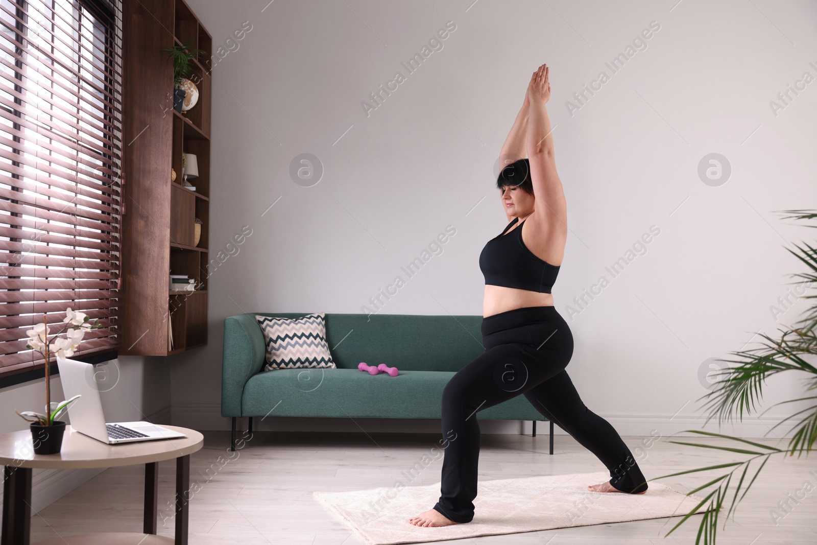 Photo of Overweight mature woman doing exercise at home, space for text