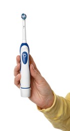 Photo of Woman holding electric toothbrush on white background, closeup