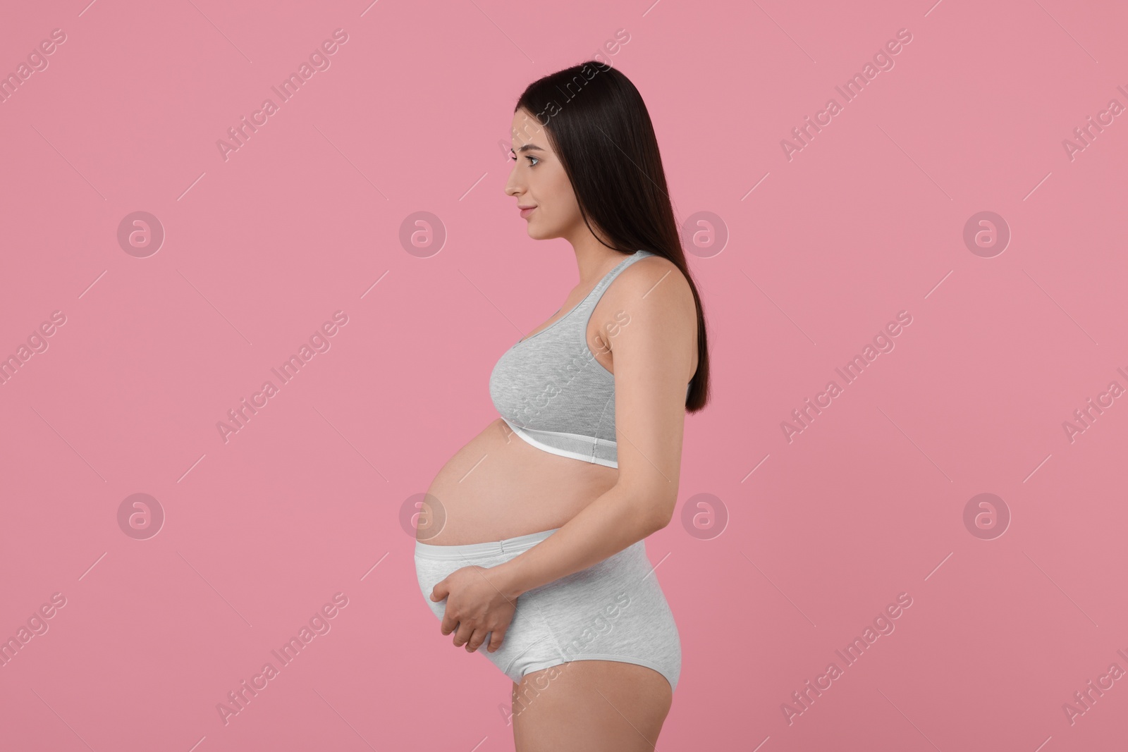 Photo of Beautiful pregnant woman in comfortable maternity underwear on pink background