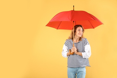 Photo of Woman with red umbrella on color background