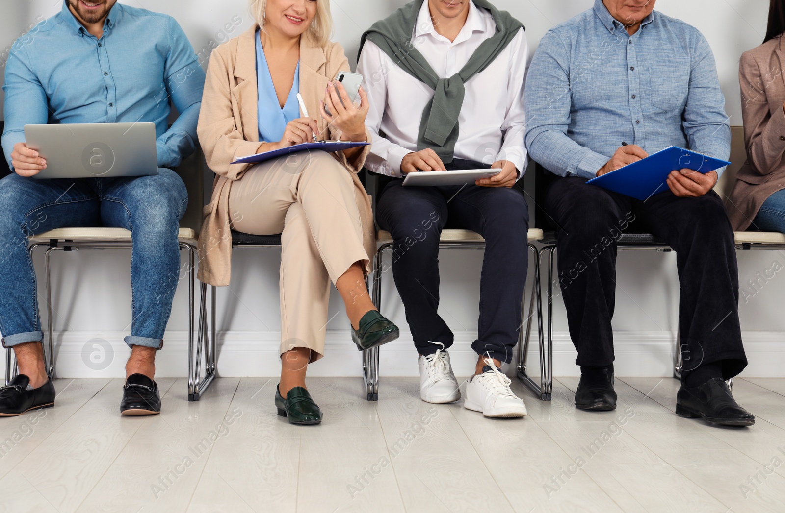 Photo of People waiting for job interview in office, closeup