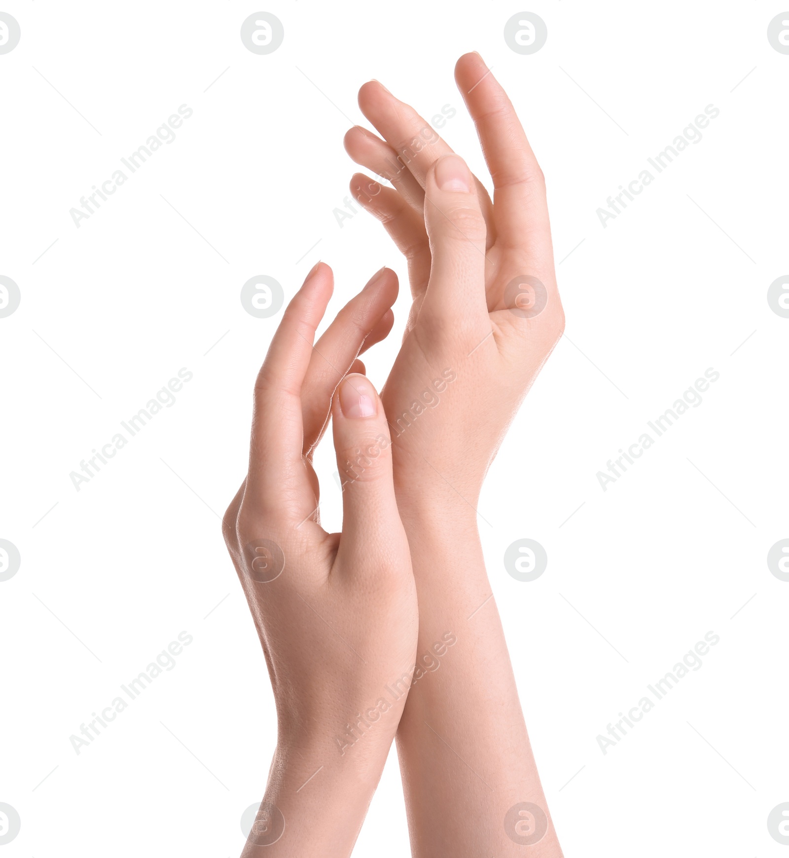 Photo of Young woman against white background. Focus on hands moisturized with cream