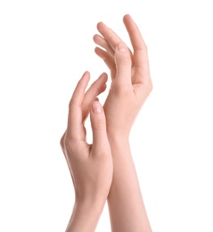 Photo of Young woman against white background. Focus on hands moisturized with cream