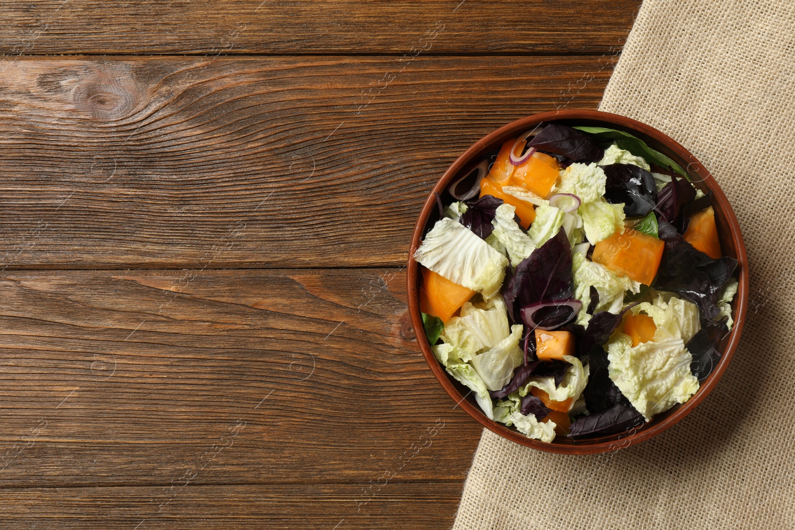 Photo of Delicious salad with Chinese cabbage, tomato and basil on wooden table, top view. Space for text