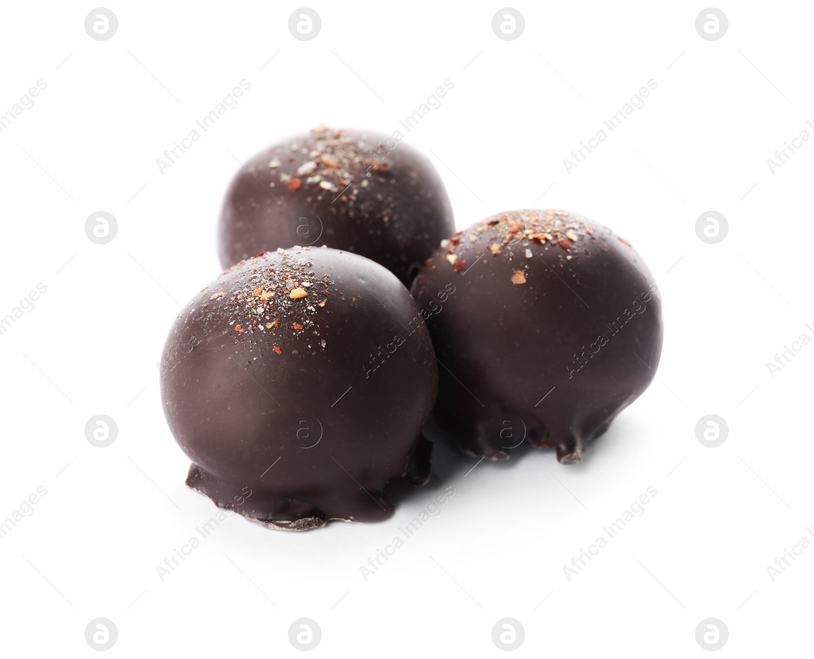 Photo of Delicious dark chocolate candies isolated on white