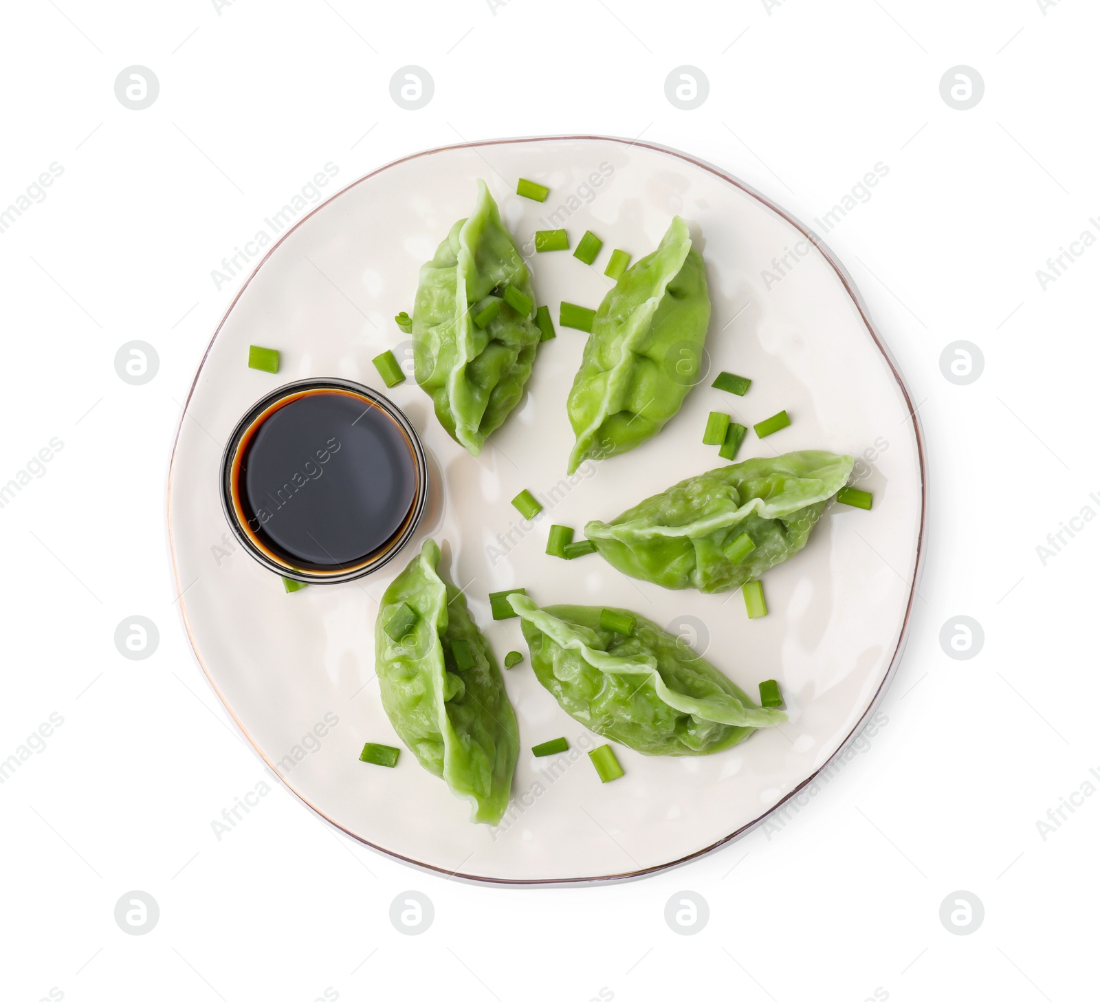 Photo of Delicious green dumplings (gyozas) and soy sauce isolated on white, top view