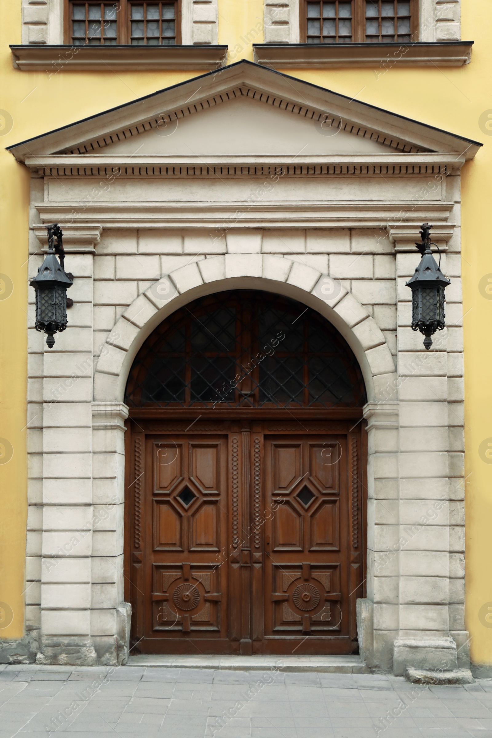 Photo of View of house with beautiful arched wooden door. Exterior design