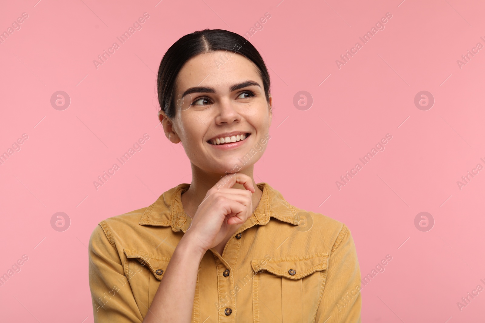 Photo of Young woman with clean teeth smiling on pink background