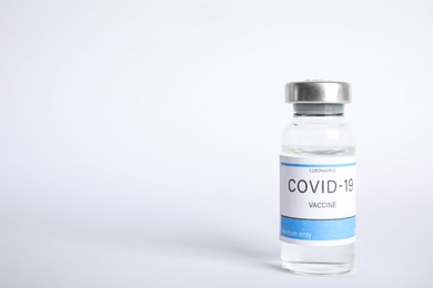 Photo of Vial with coronavirus vaccine on white background, space for text