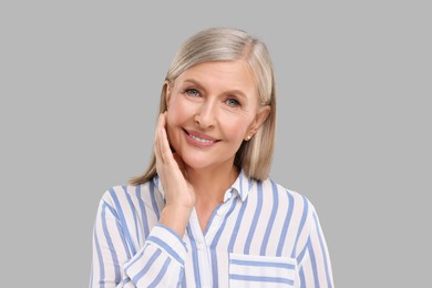 Photo of Portrait of beautiful middle aged woman on light grey background