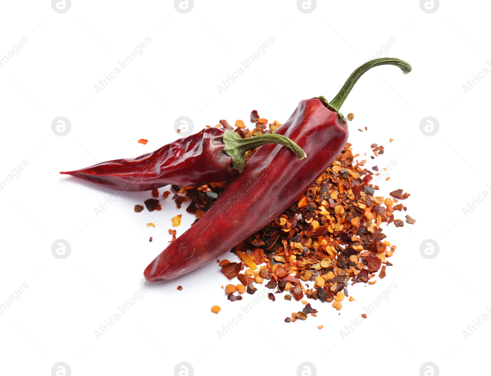 Photo of Dry chili peppers and powder on white background