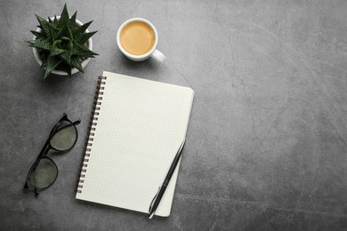 Flat lay composition with notebook on grey table