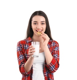 Photo of Beautiful young woman drinking milk with cookie on white background