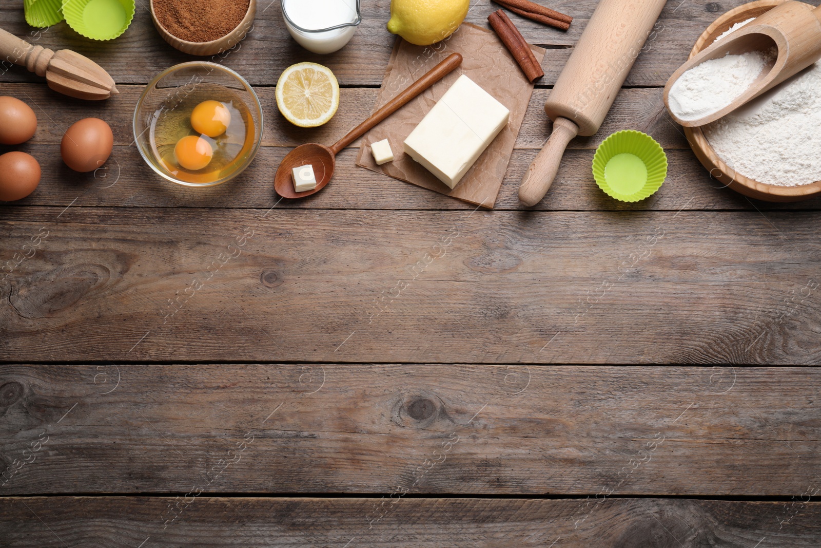 Photo of Cooking utensils and ingredients on wooden table, flat lay. Space for text