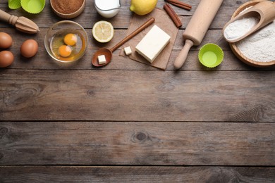 Photo of Cooking utensils and ingredients on wooden table, flat lay. Space for text