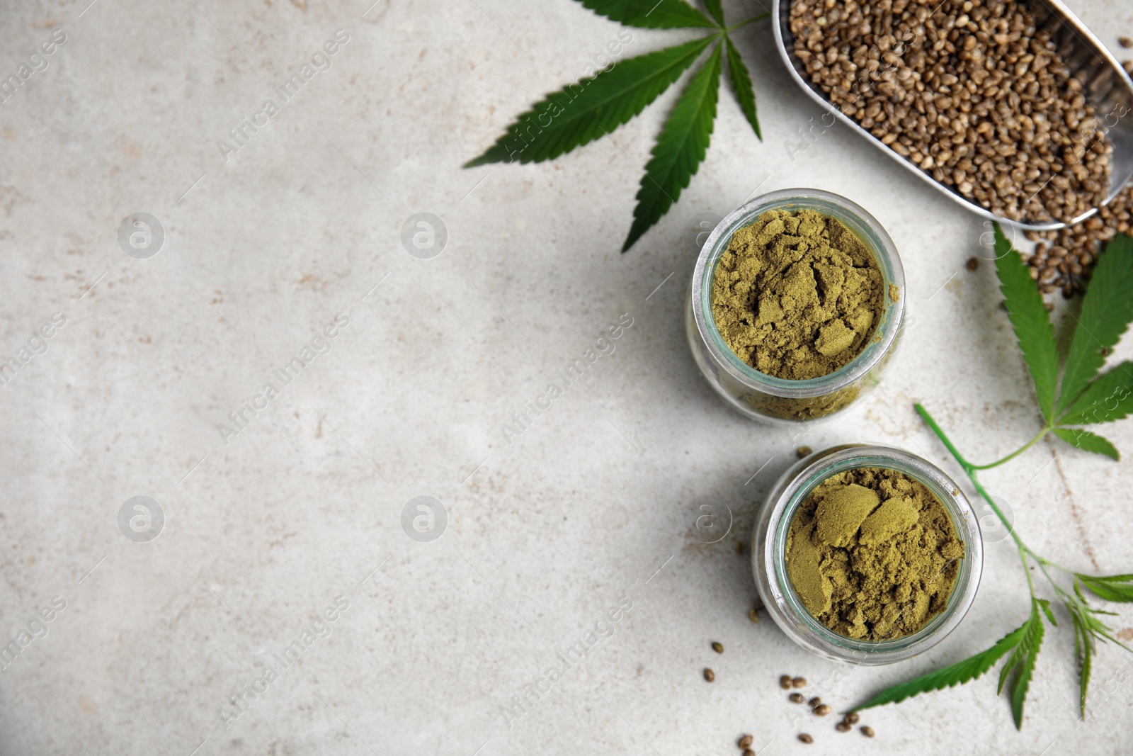 Photo of Hemp protein powder, seeds and fresh leaves on light grey table, flat lay. Space for text