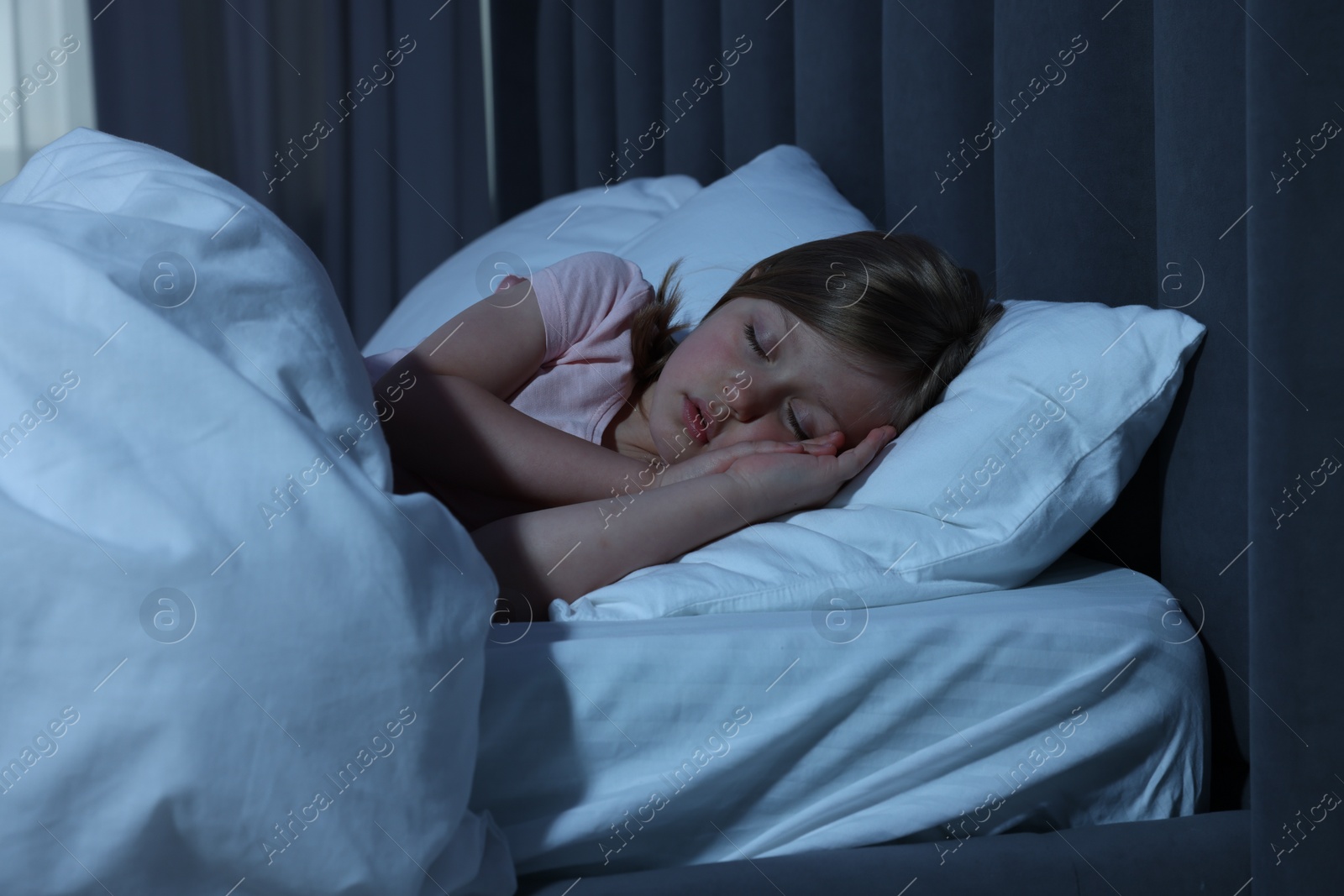 Photo of Little girl snoring while sleeping in bed at home