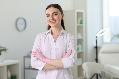 Photo of Cosmetologist in medical uniform in modern clinic