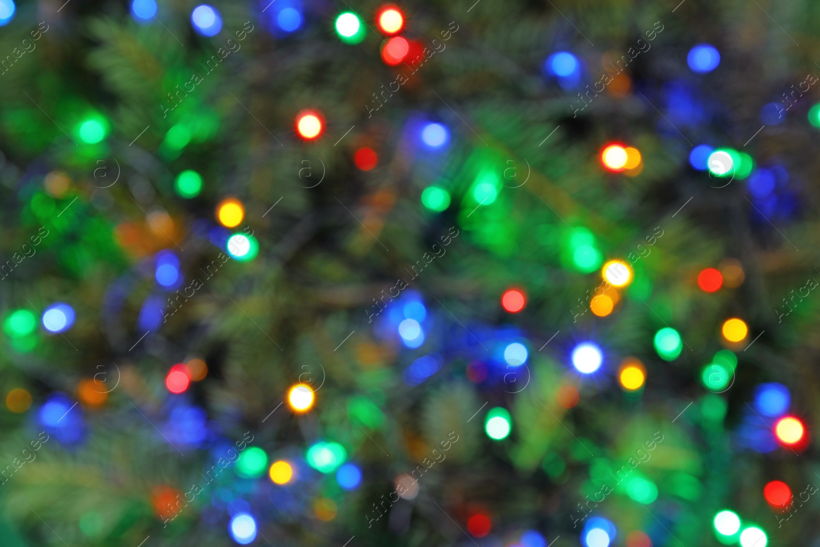 Photo of Blurred view of glowing Christmas lights as background