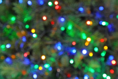 Blurred view of glowing Christmas lights as background