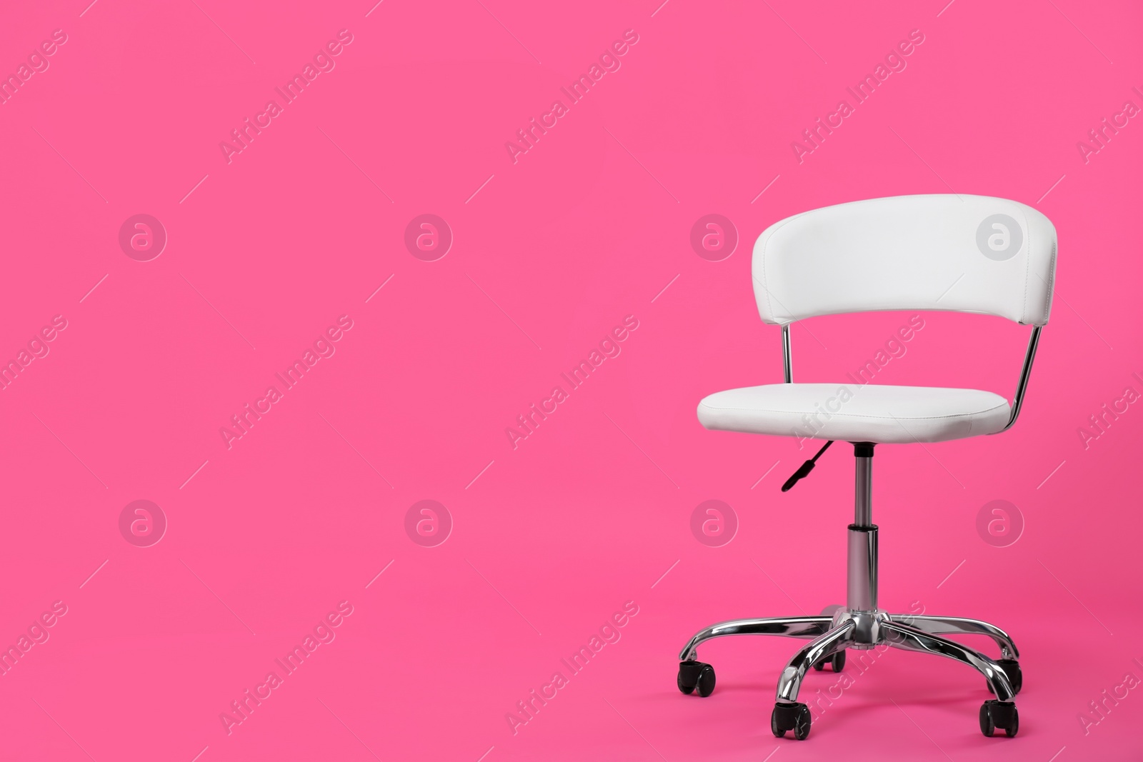 Photo of Comfortable office chair on pink background, space for text