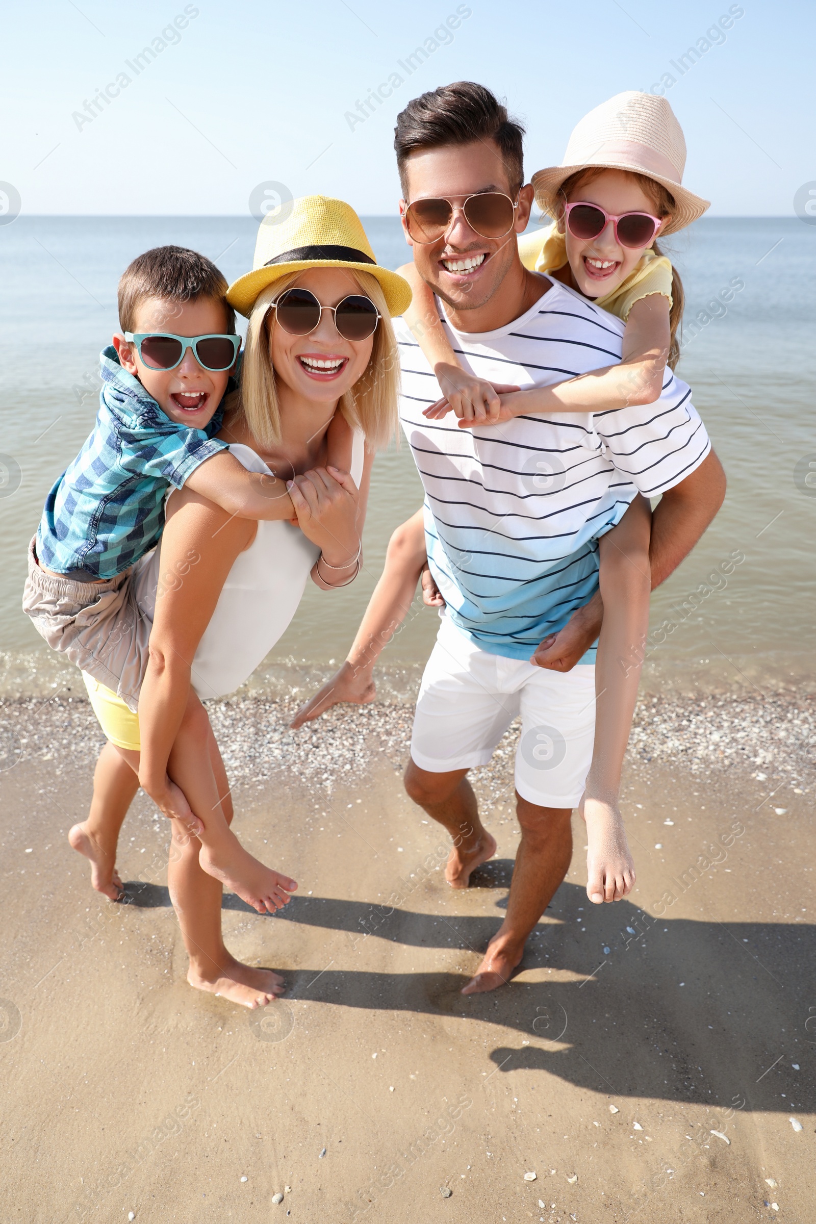 Photo of Happy family at beach on sunny summer day