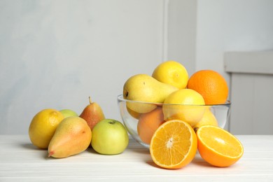 Photo of Different fresh fruits on white wooden table. Food poisoning concept