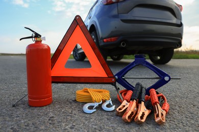 Photo of Emergency warning triangle and car safety equipment outdoors