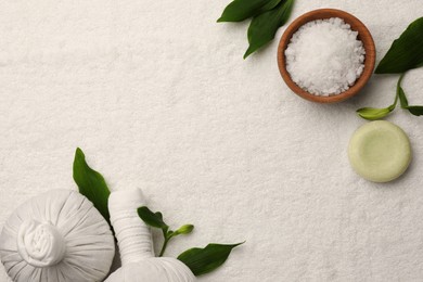 Photo of Flat lay composition with spa products and leaves on white towel. Space for text