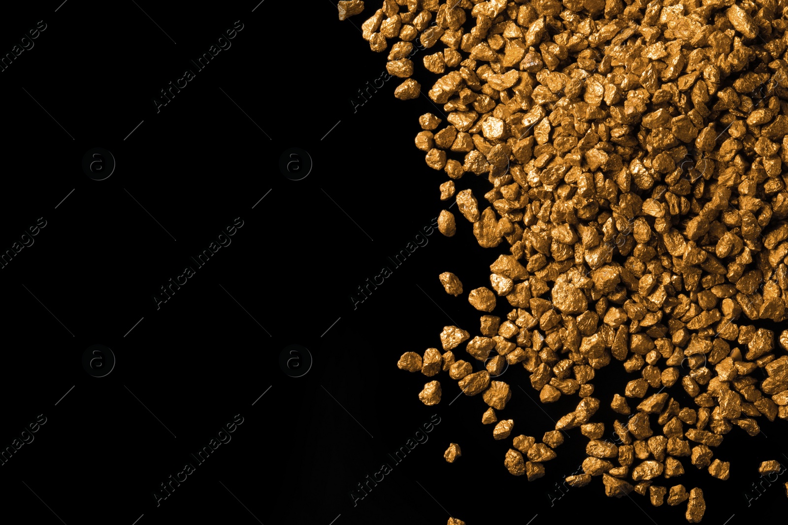 Photo of Pile of gold nuggets on black background, flat lay. Space for text