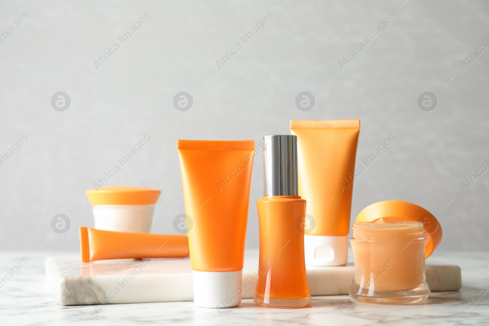 Photo of Set of luxury cosmetic products on white marble table