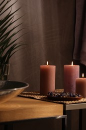 Spa composition. Burning candles and dry flowers on table indoors