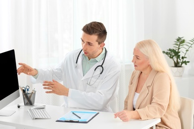 Photo of Doctor working with mature patient in hospital