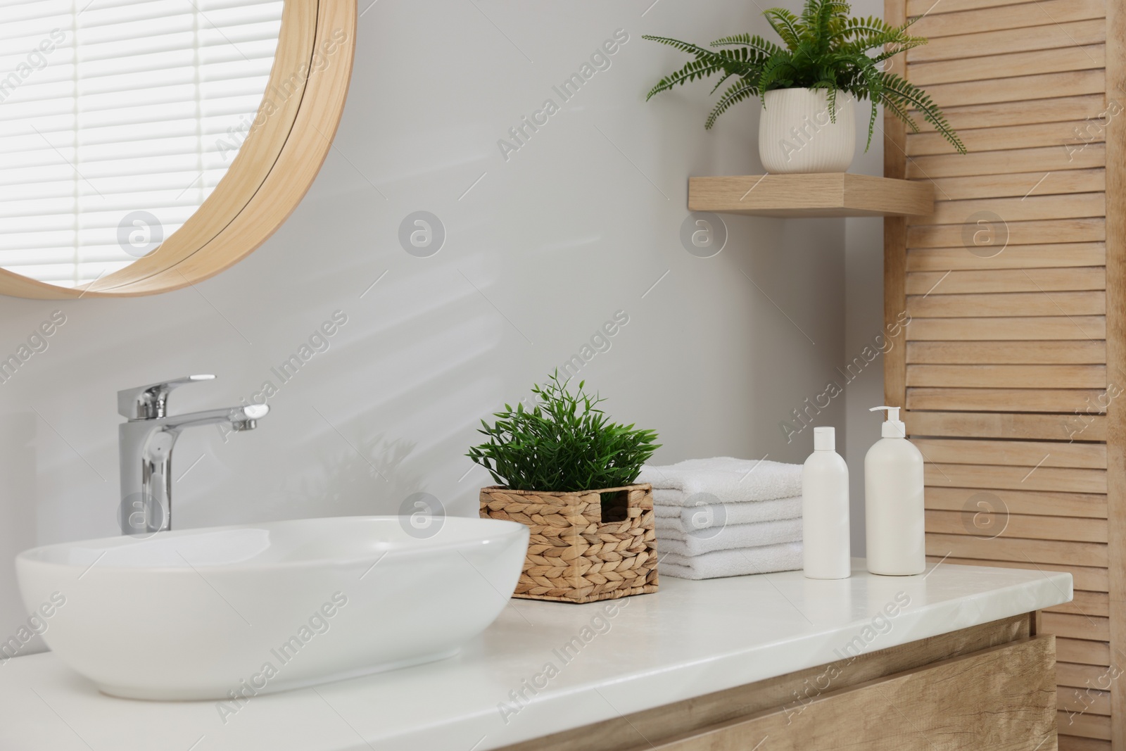 Photo of Different potted artificial plants in bathroom. Home decor