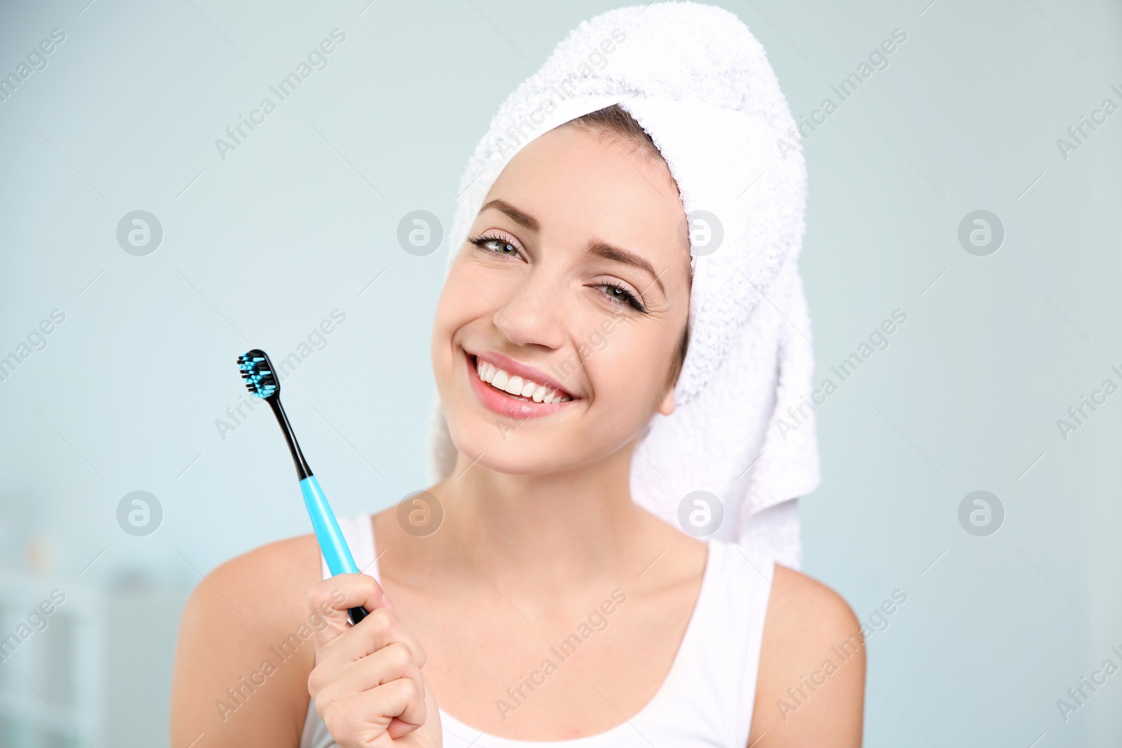 Photo of Portrait of young woman with toothbrush on blurred background