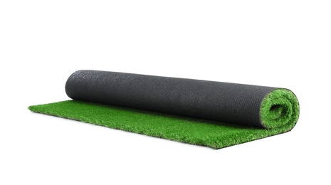 Photo of Rolled artificial grass carpet on white background. Exterior element