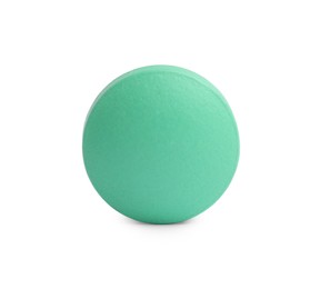 Photo of One light green pill on white background. Medicinal treatment