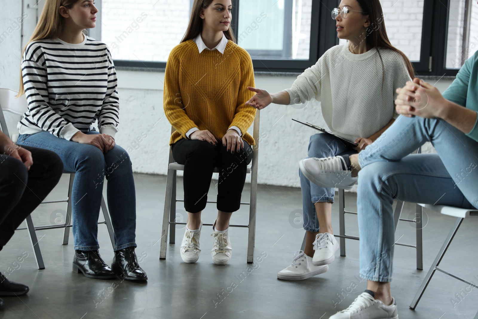 Photo of Psychotherapist working with patients in group therapy session, closeup