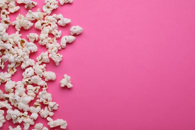 Tasty popcorn on pink background, flat lay. Space for text