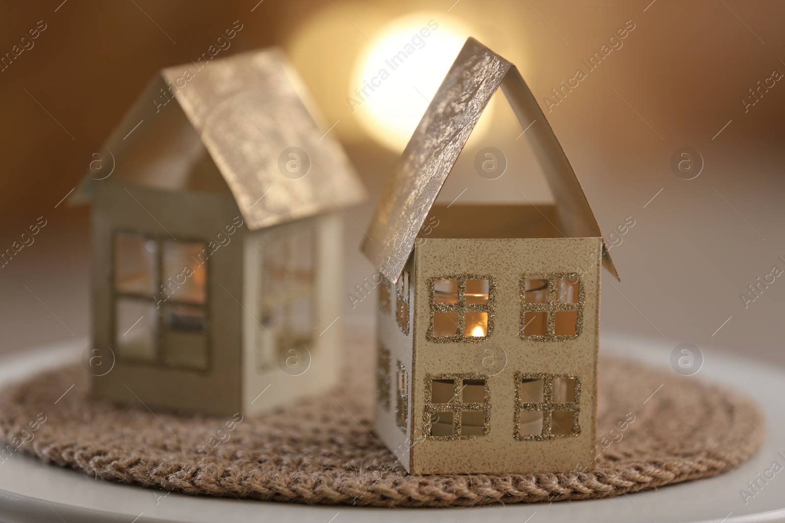 Photo of House shaped candle holder on table. Christmas decoration