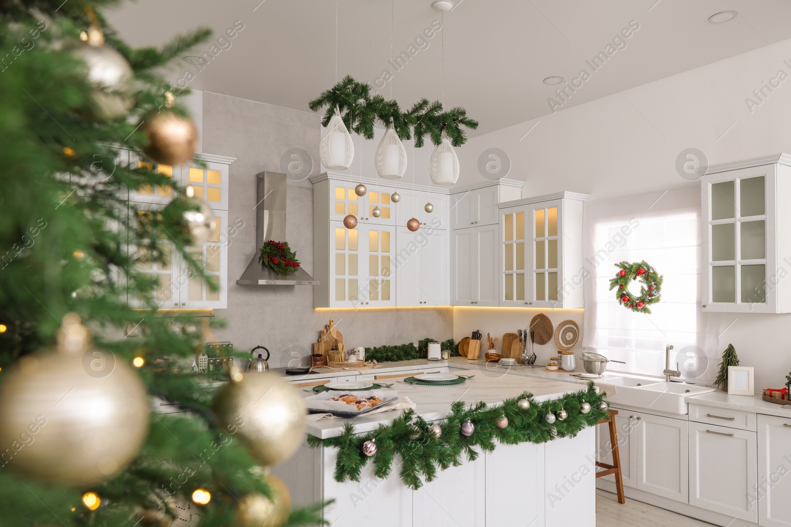 Photo of Cozy spacious kitchen decorated for Christmas. Interior design