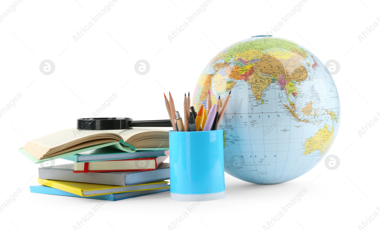 Photo of Plastic model globe of Earth, colorful pencils, magnifying glass and books on white background. Geography lesson