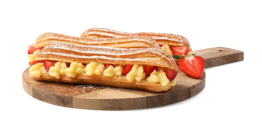 Photo of Delicious eclairs filled with cream and strawberries isolated on white