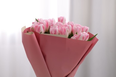 Photo of Beautiful bouquet of fresh pink tulips on blurred background, closeup