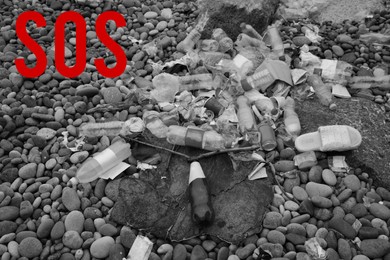 Image of Word SOS and garbage scattered on pebbles outdoors. Recycling problem