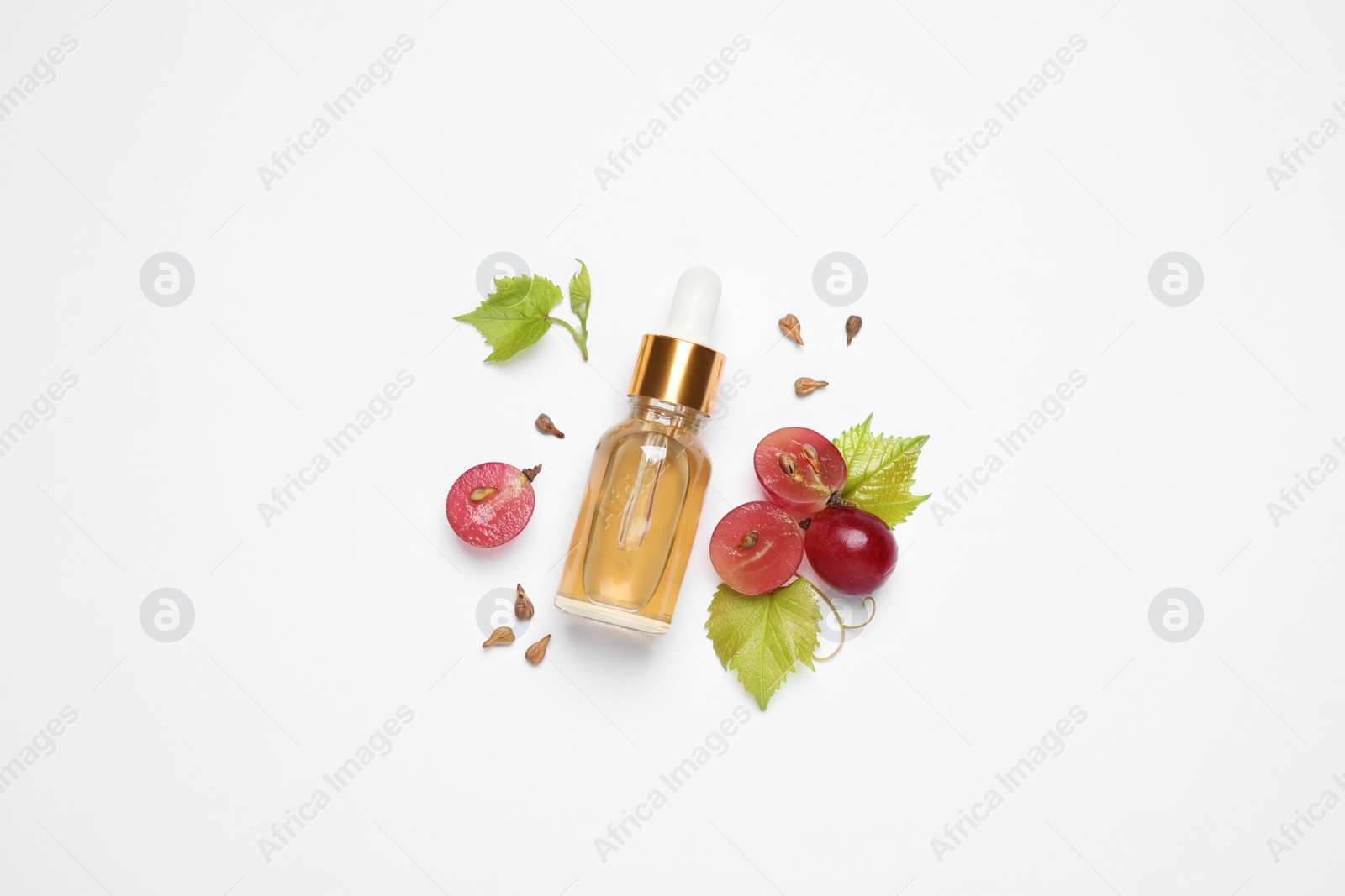 Photo of Composition with bottle of natural grape seed oil on white background, top view. Organic cosmetic