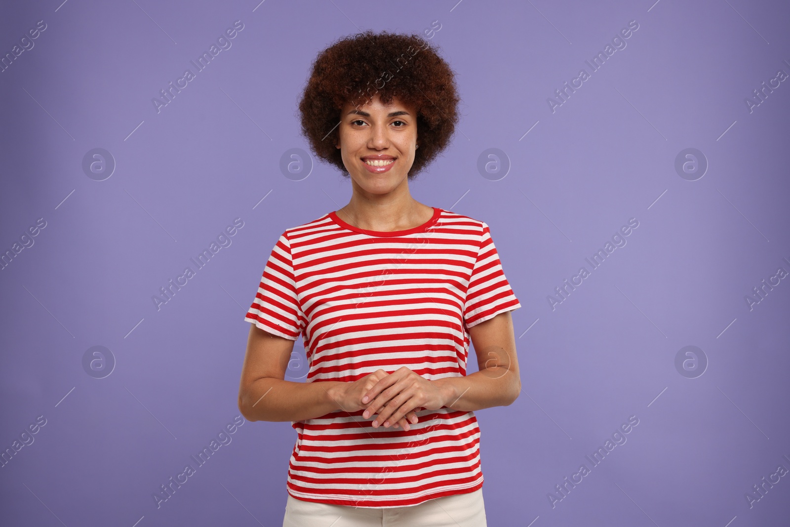 Photo of Portrait of happy young woman on purple background