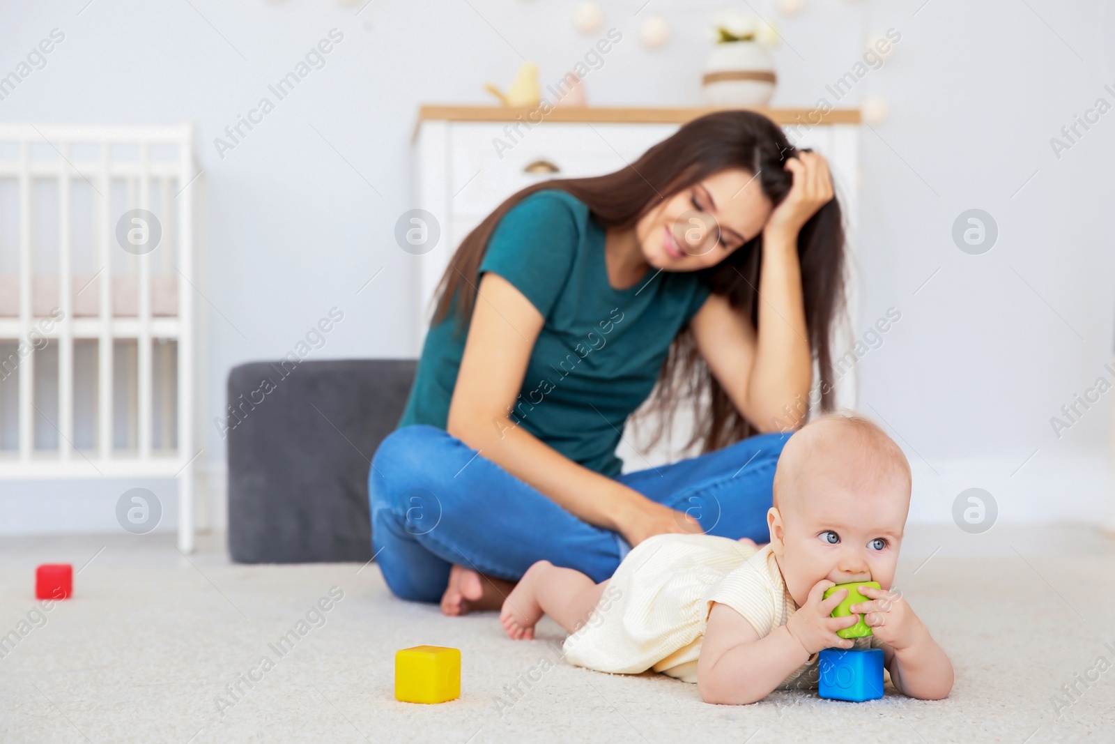 Photo of Young mother and cute baby girl at home