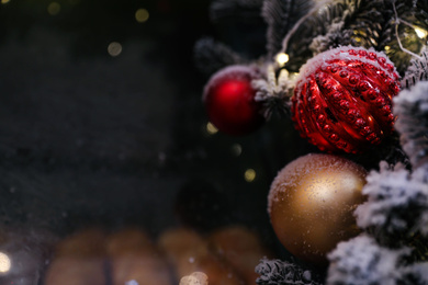 Photo of Beautiful Christmas balls on blurred background outdoors, closeup