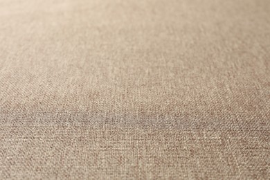 Photo of Texture of light brown fabric as background, closeup